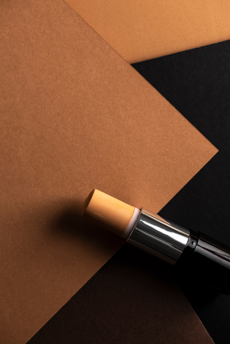Concealer Stick on a Geometric Background
